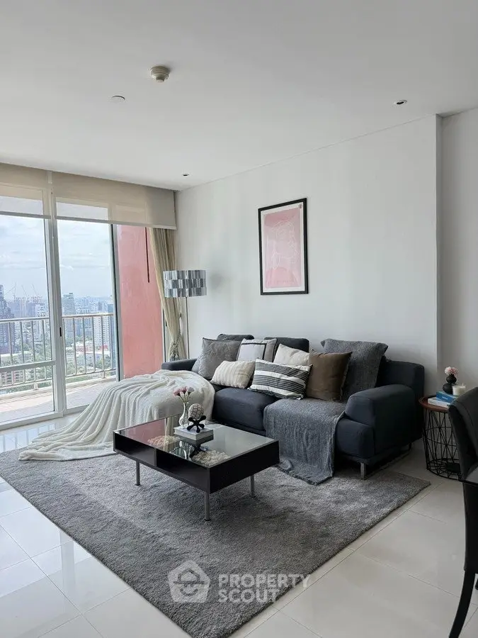 Modern living room with cozy sofa and city view balcony