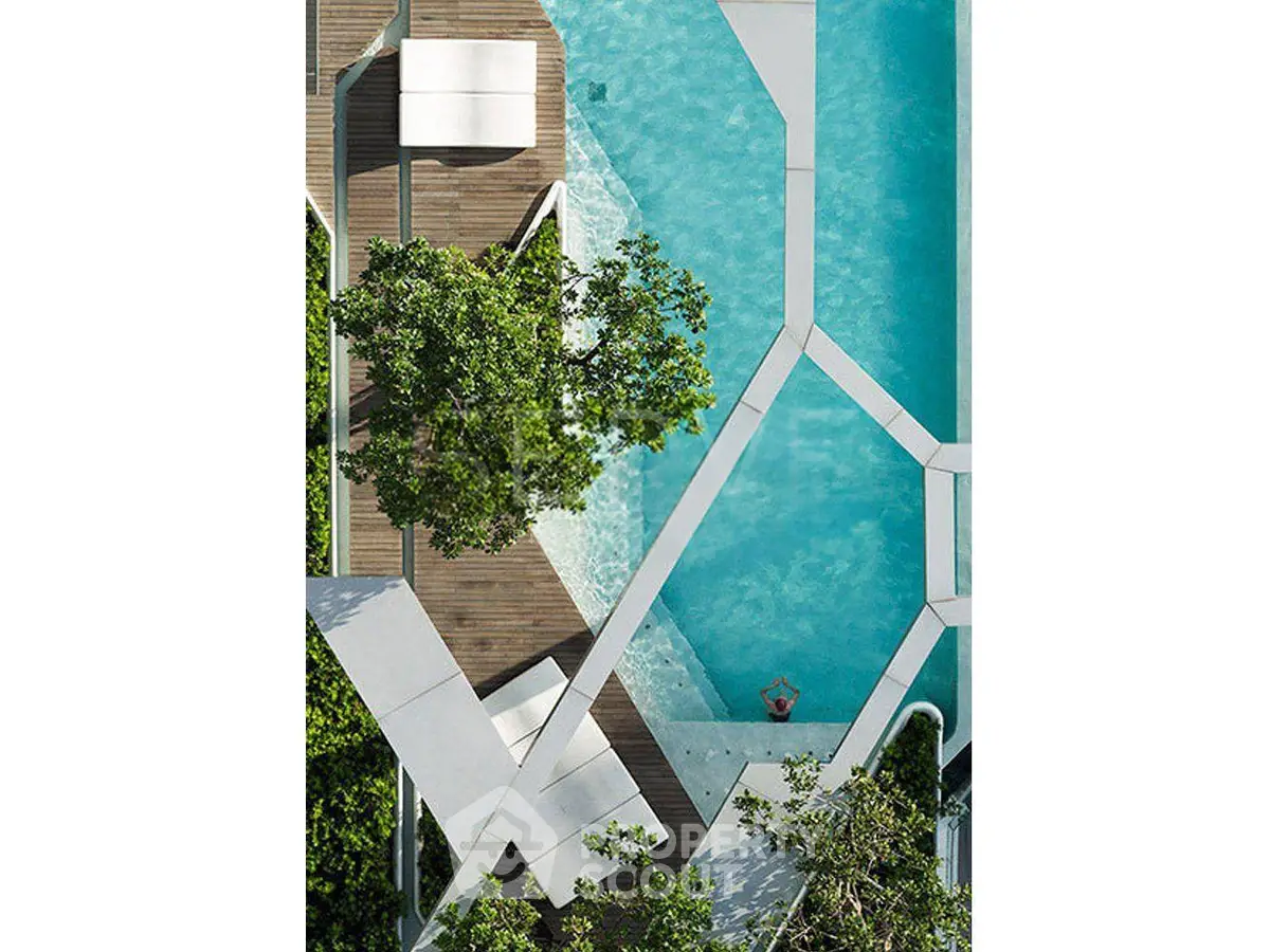 Stunning aerial view of modern pool with geometric design and lush greenery.