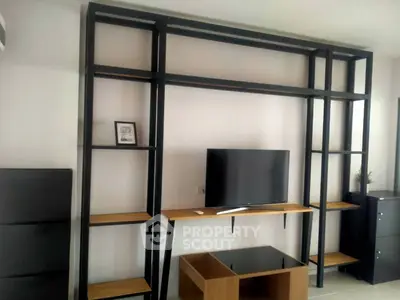 Modern living room with sleek shelving and flat-screen TV, perfect for contemporary urban living.