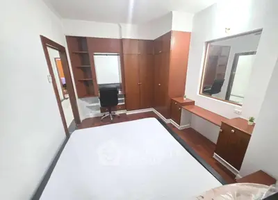 Spacious bedroom with built-in wardrobe and study desk, perfect for modern living.