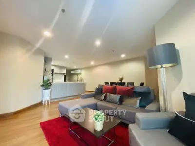 Spacious modern living room with cozy seating and open kitchen layout