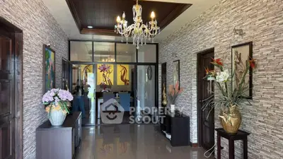 Elegant hallway with chandelier and modern decor leading to dining area