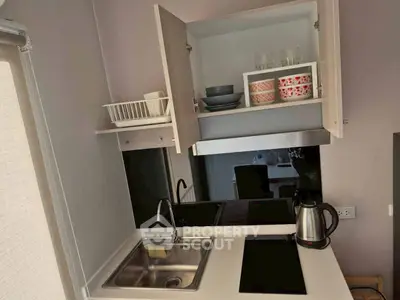 Compact modern kitchen with open cabinets and electric stove