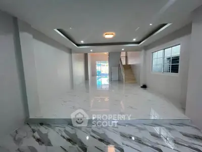 Spacious modern living room with marble flooring and elegant lighting