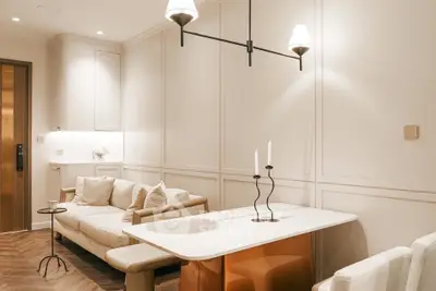 Elegant living room with modern lighting and cozy seating area, perfect for relaxation.