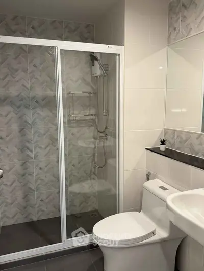 Modern bathroom with glass shower enclosure and sleek fixtures