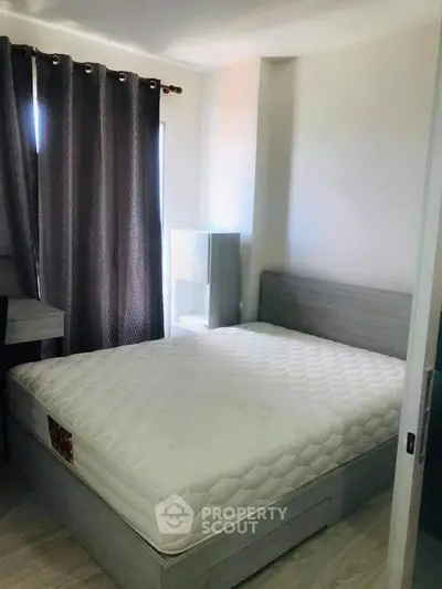 Cozy bedroom with modern furnishings and natural light, perfect for relaxation and comfort.