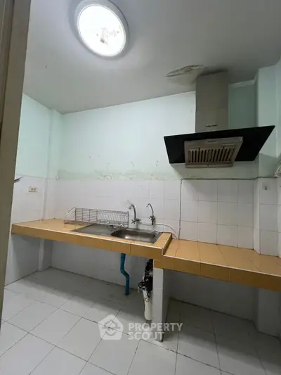 Spacious kitchen with modern extractor fan and ample counter space