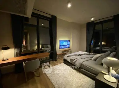 Luxurious modern bedroom with elegant decor and city view, featuring a cozy bed and stylish workspace.