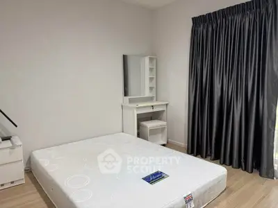 Spacious bedroom with modern furnishings and natural light