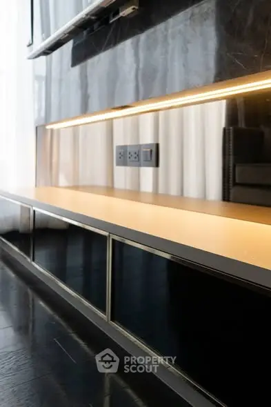 Modern interior with sleek black cabinetry and ambient lighting, perfect for contemporary living spaces.