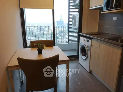 Modern kitchen with dining area and city view from balcony
