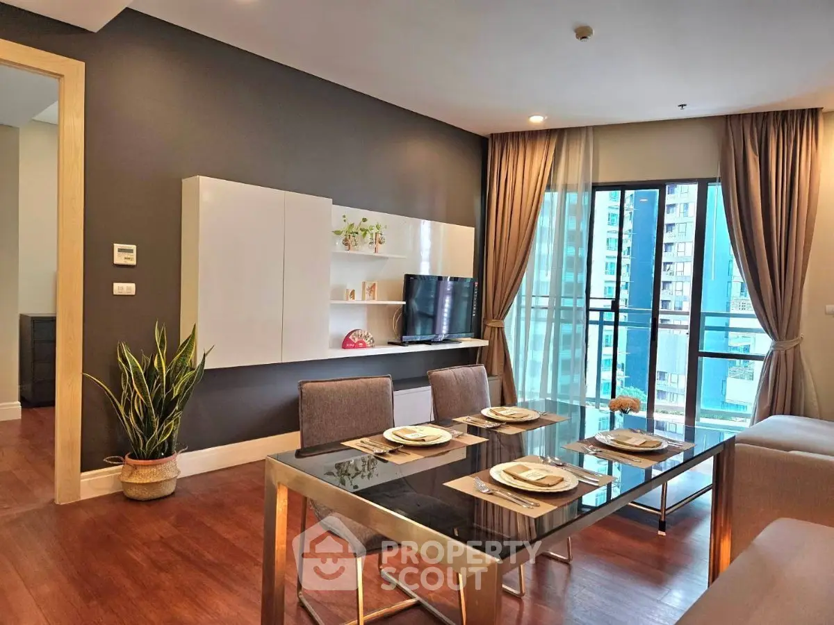 Modern living room with elegant dining area and city view balcony