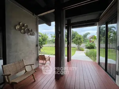 Charming patio with wooden deck and garden view, perfect for relaxation and outdoor enjoyment.