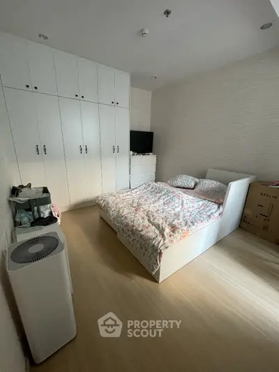 Bright and cozy bedroom with large built-in wardrobes and ample natural light, perfect for restful nights and efficient storage solutions.