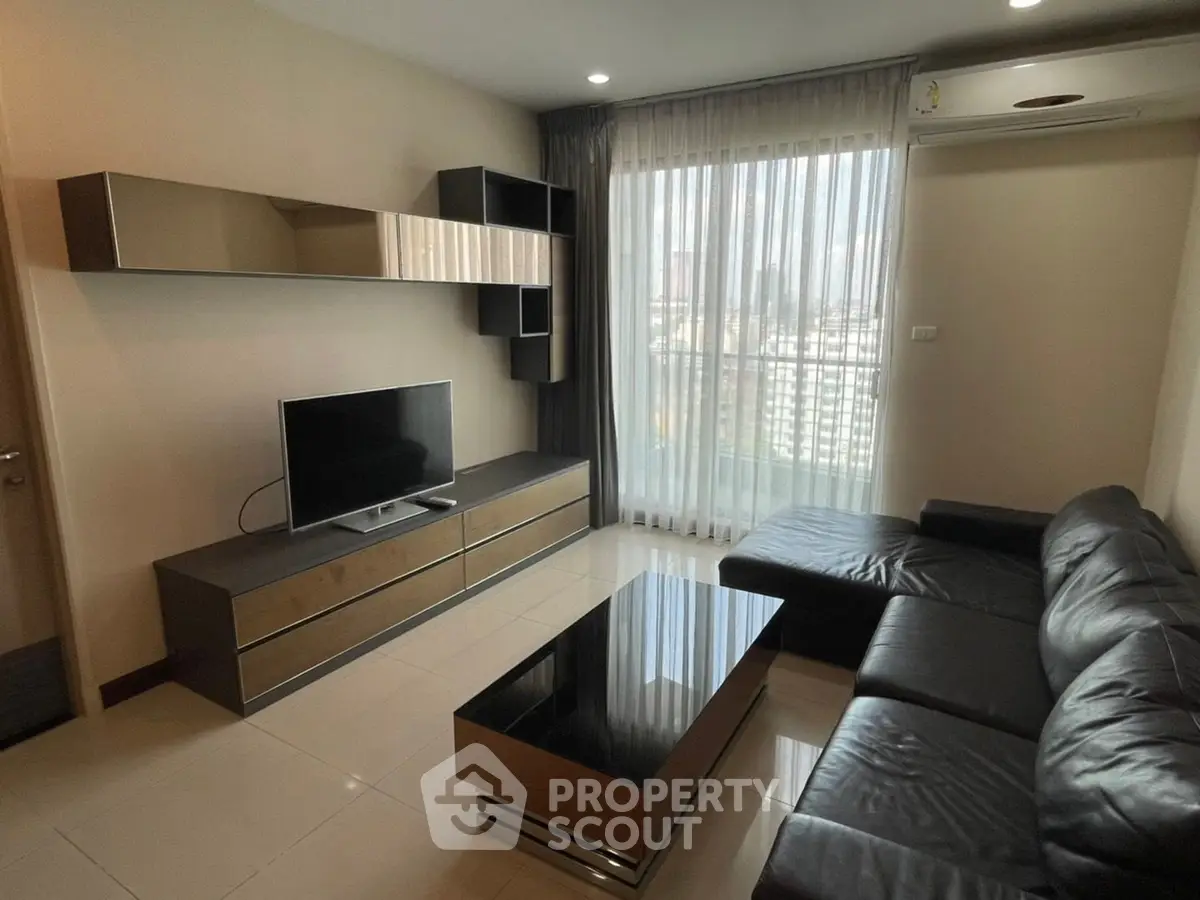 Modern living room with sleek furniture and city view, perfect for urban living.