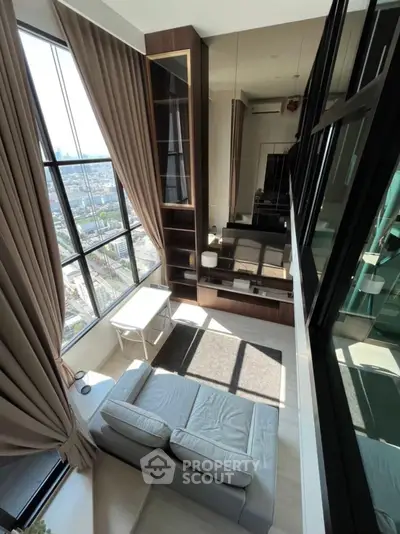 Stunning high-rise living room with floor-to-ceiling windows and breathtaking city view.