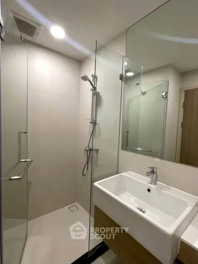 Modern bathroom with glass shower and sleek sink design