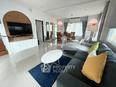 Spacious modern living room with sleek design and ample natural light, perfect for relaxation and entertainment.