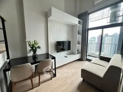 Modern living room with city view, featuring sleek furniture and large windows for natural light.