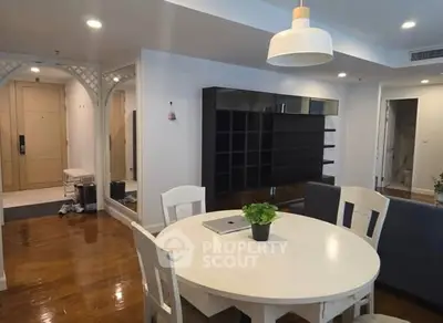 Spacious dining area with modern decor and wooden flooring in a stylish apartment.
