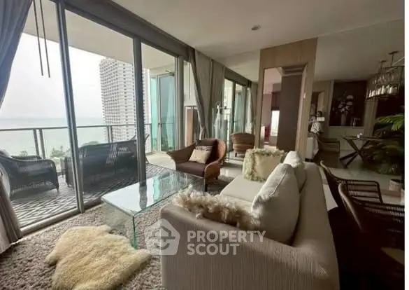 Luxurious living room with stunning ocean view and spacious balcony.