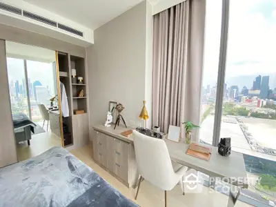 Modern bedroom with city view and stylish decor in high-rise apartment