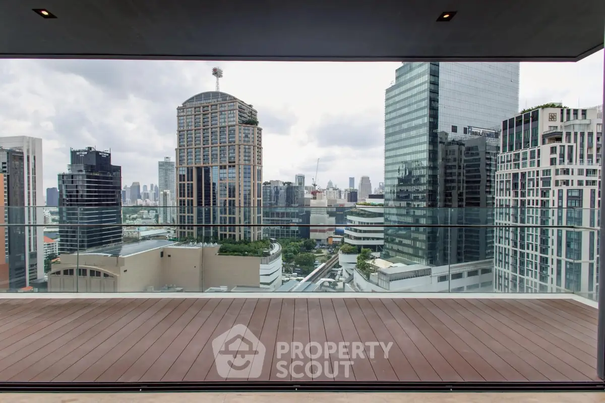 Stunning cityscape view from a modern balcony with glass railing, perfect for urban living.