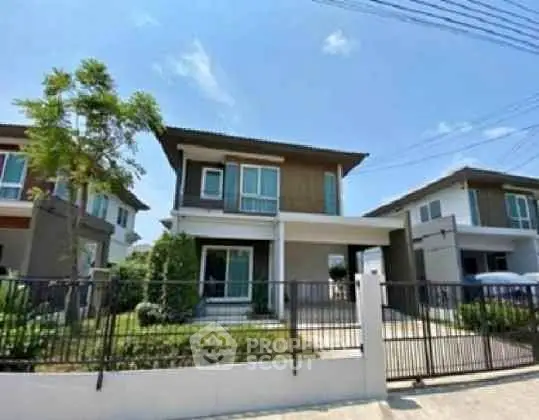 Modern two-story house with spacious front yard and gated entrance