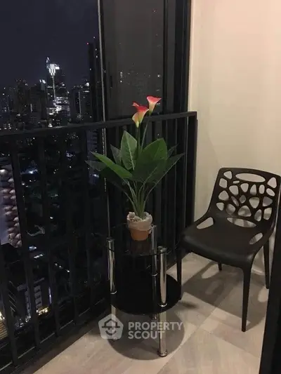 Chic urban balcony with city skyline view, modern chair, and elegant potted plant for serene relaxation.