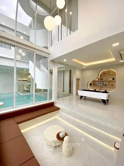 Luxurious modern living room with pool view and stylish decor