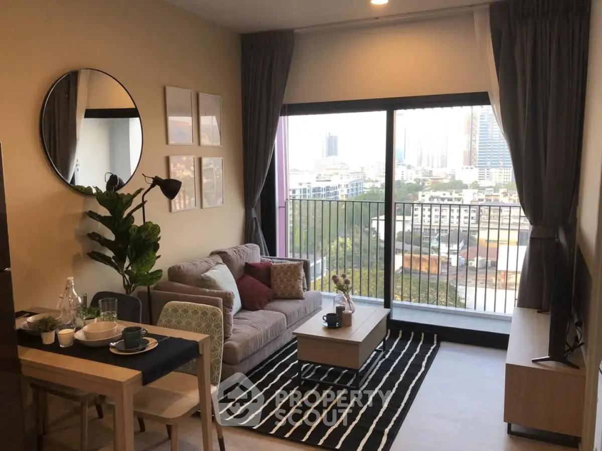 Modern living room with city view, stylish decor, and cozy seating area.