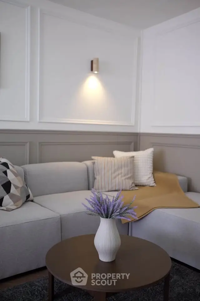 Elegant living room with modern gray sofa and stylish decor