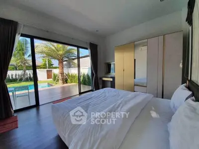 Luxurious bedroom with pool view and modern furnishings