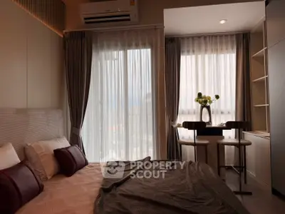 Cozy bedroom with city view and dining nook, featuring elegant curtains and modern decor.
