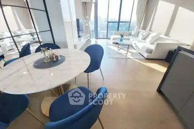 Luxurious modern living room with city view, elegant furniture, and abundant natural light.