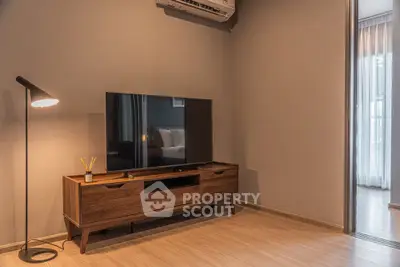 Modern living room with sleek wooden TV stand and stylish floor lamp.