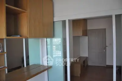 Modern interior with sliding glass doors and wooden cabinetry, maximizing space and light.