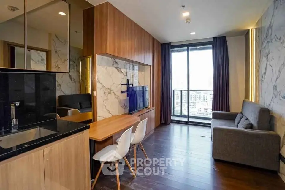 Modern living room with stylish decor and city view balcony in luxury apartment.