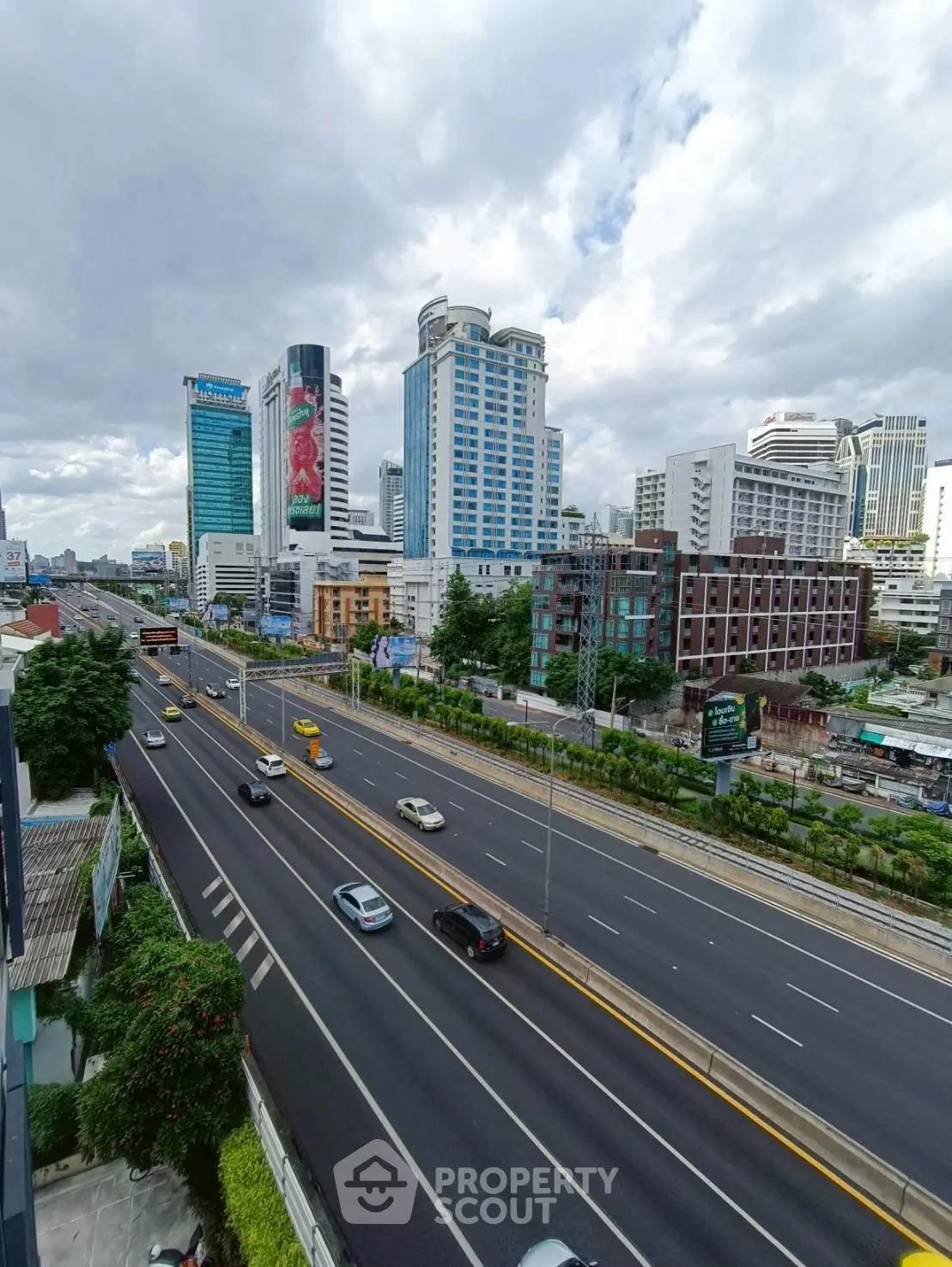 Stunning cityscape view with modern skyscrapers and busy highway, perfect for urban living enthusiasts.