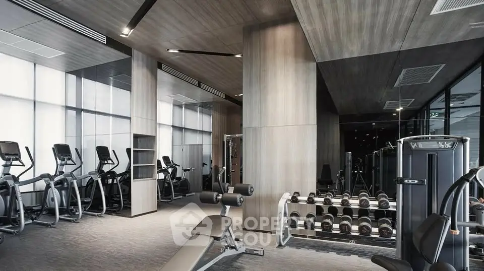 Modern gym with state-of-the-art equipment and sleek design in luxury building.