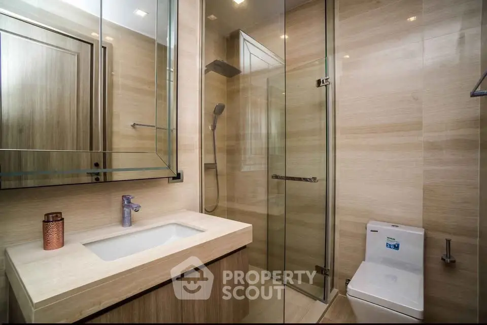 Luxurious modern bathroom with glass shower and elegant fixtures