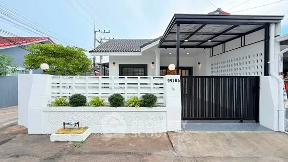 Charming modern house with gated entrance and lush greenery, perfect for family living.