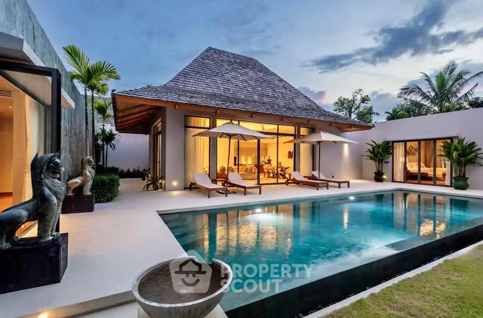 Luxurious villa with private pool and elegant outdoor seating at sunset.