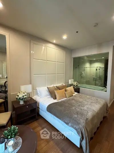 Luxurious bedroom with elegant decor and glass-walled bathroom