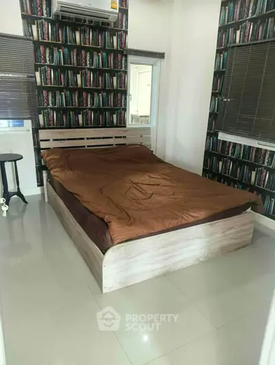Cozy bedroom with modern design and unique bookshelf wallpaper