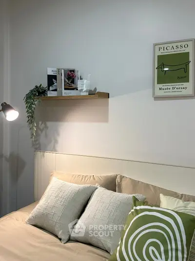 Cozy bedroom with stylish decor, featuring a comfortable bed and elegant wall art.