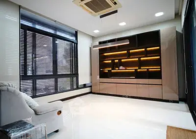 Modern living room with sleek built-in shelving and large windows
