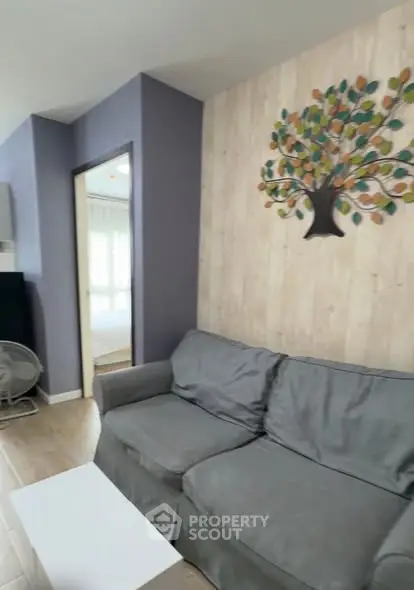 Cozy living room with modern decor and comfortable seating in a stylish apartment.