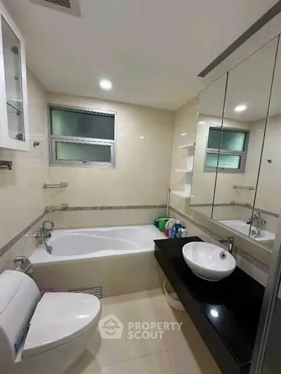 Modern bathroom with bathtub and sleek fixtures in a contemporary home.